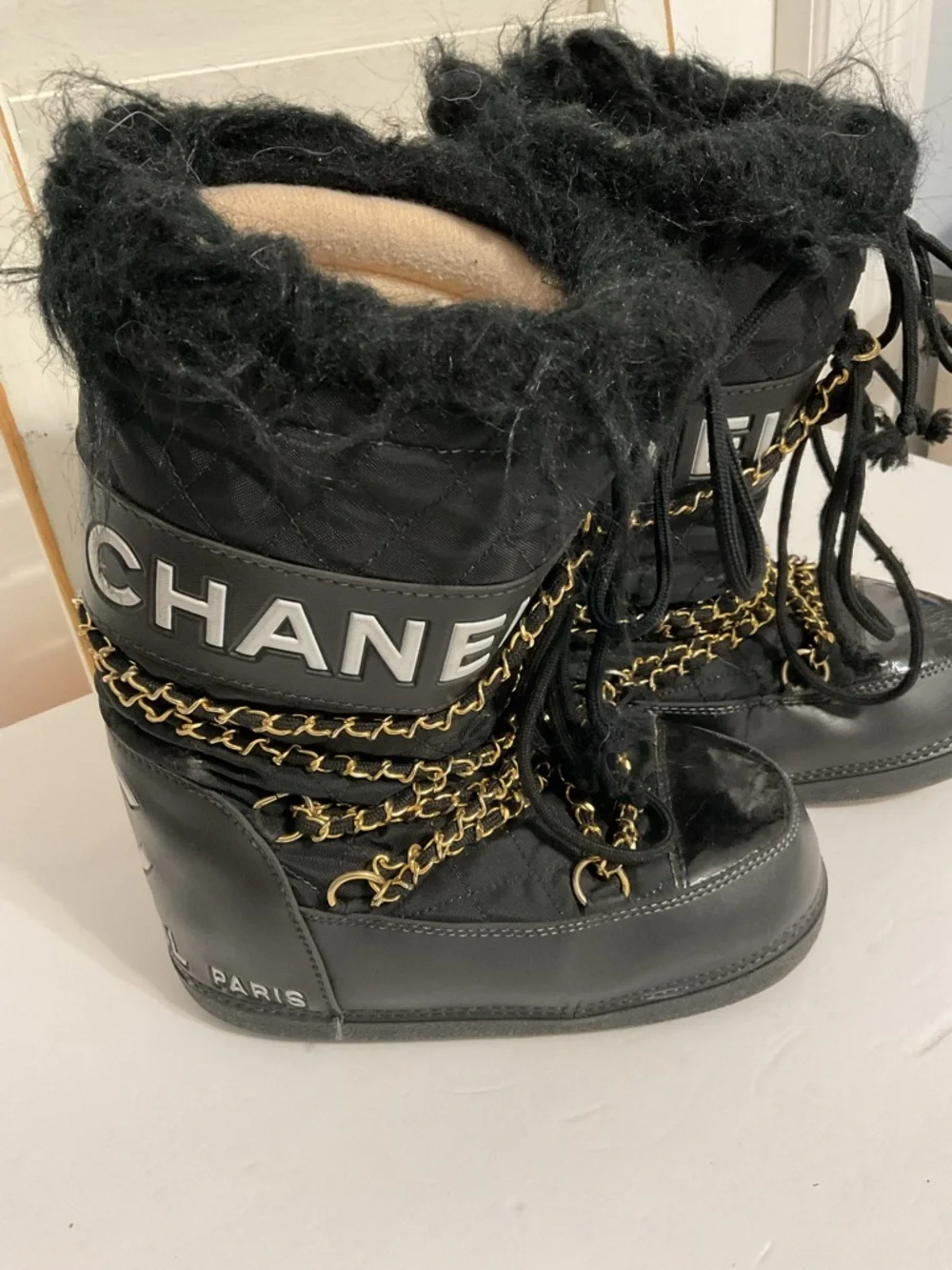 CHANEL Black and Gold Quilted Winter Lace-Up Boots